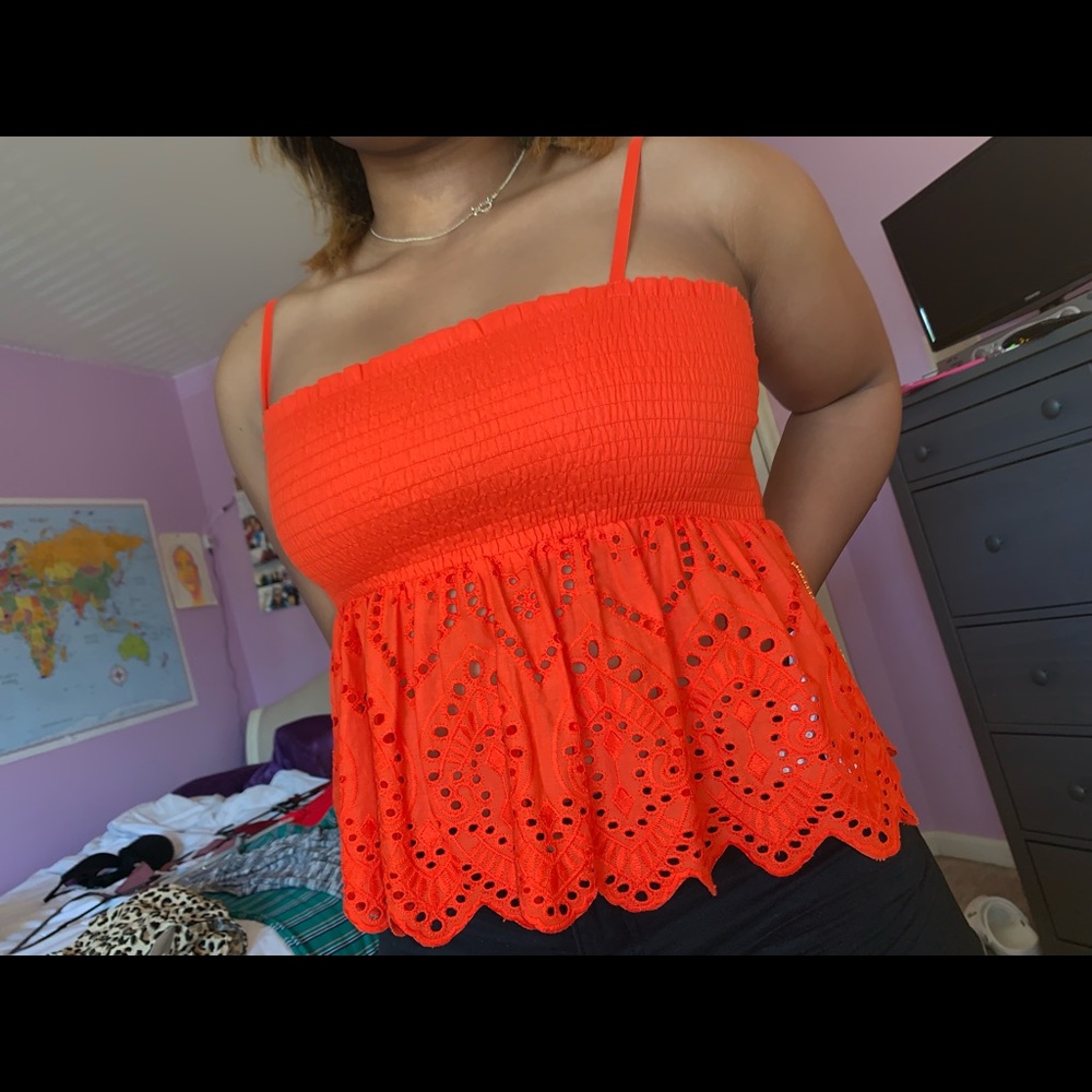 Summer blouse. Orange with small cutout details.